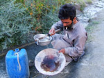 A Balti demonstrates panning for gold. Hushe, Pakistan.