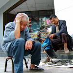 A cobbler and his father. Chengdu, Sichuan.