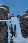 Unknown climber abseiling an ice pitch in the Dolomites, Italy.